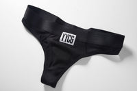Black Ribbed Thong studio flat-lay — YYCG women's ribbed bamboo-rayon underwear