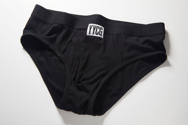 Black YYCG underwear photographed flat on a neutral background