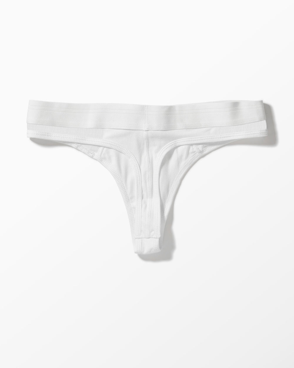 White Ribbed Thong studio flat-lay — YYCG women's ribbed bamboo-rayon underwear

