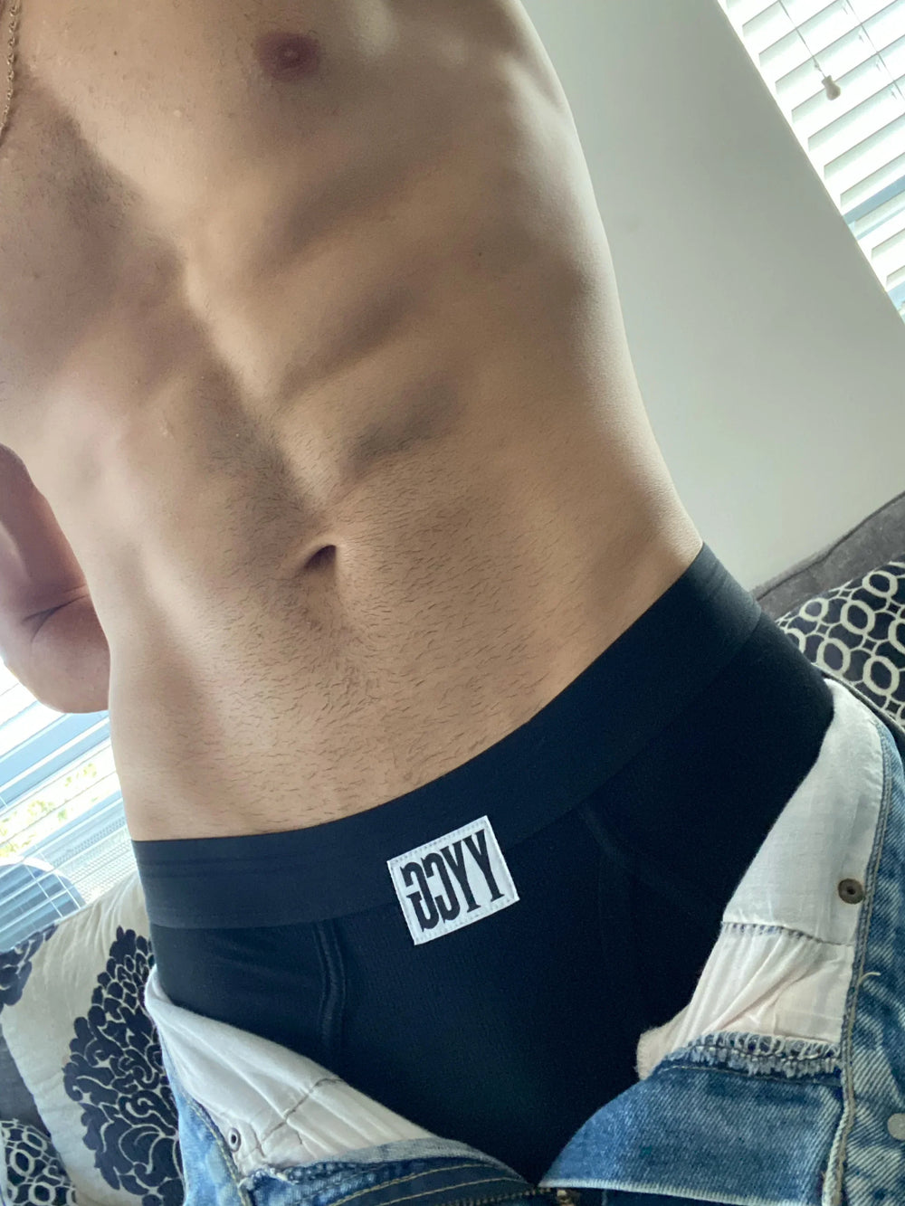 Model wearing the black Ribbed Brief — YYCG men's ribbed bamboo-rayon underwear
