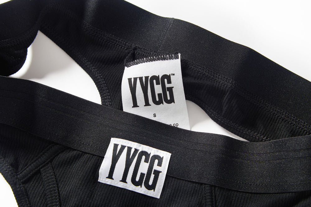 Black Ribbed Thong studio flat-lay — YYCG women's ribbed bamboo-rayon underwear
