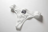 White Ribbed Thong studio flat-lay — YYCG women's ribbed bamboo-rayon underwear
