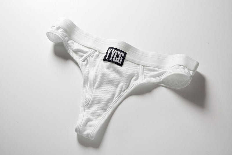 White Ribbed Thong studio flat-lay — YYCG women's ribbed bamboo-rayon underwear
