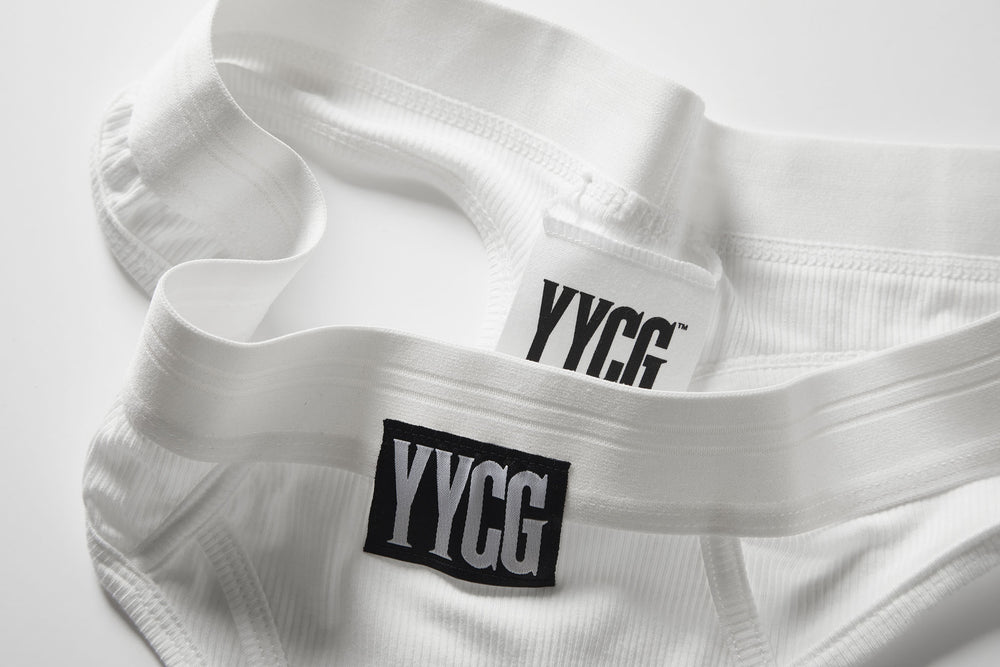 White Ribbed Thong studio flat-lay — YYCG women's ribbed bamboo-rayon underwear
