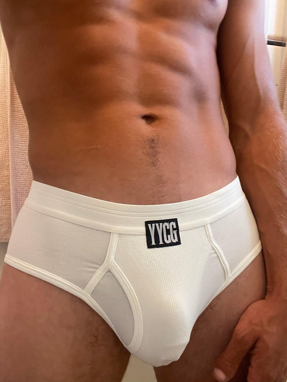 Model wearing the white Ribbed Brief — YYCG men's ribbed bamboo-rayon underwear
