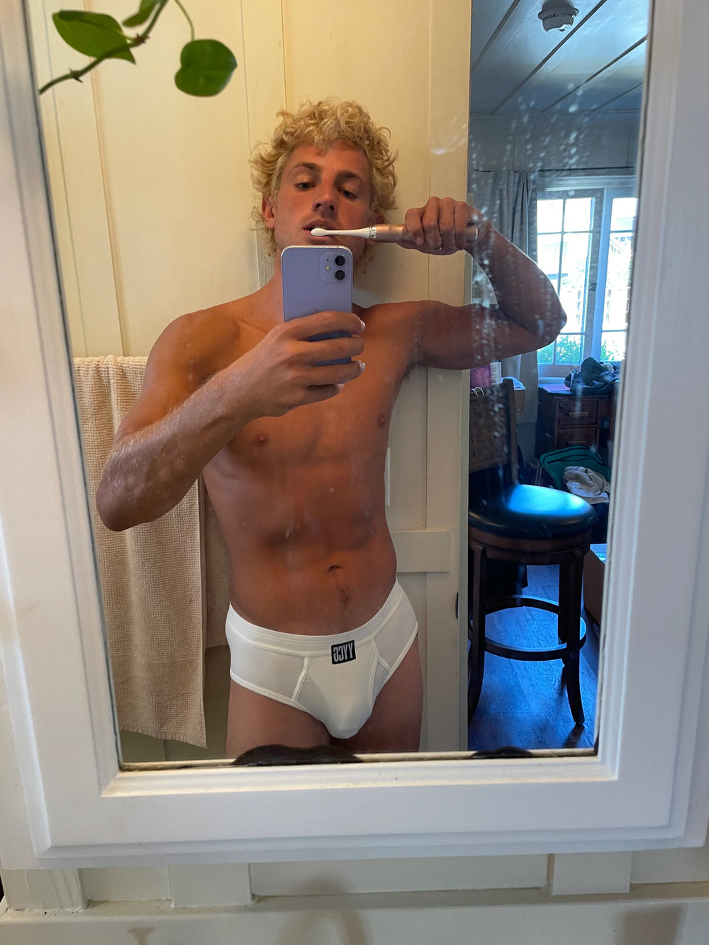 Model wearing the white Ribbed Brief — YYCG men's ribbed bamboo-rayon underwear
